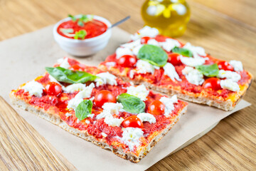 Pizza margarita with cherry tomato, basil and morzzarella cheese