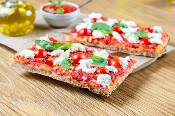 Pizza margarita with cherry tomato, basil and morzzarella cheese