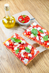 Fototapeta na wymiar Pizza margarita with cherry tomato, basil and morzzarella cheese