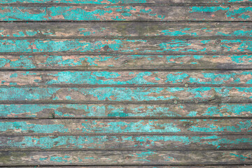 Texture of an old wooden table with peeling blue paint