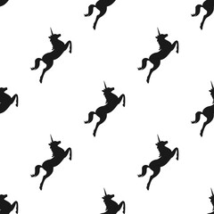 seamless fantasy pattern with silhouette of unicorns.