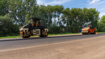 Two asphalt roller machine. Road repair works on the suburb highway