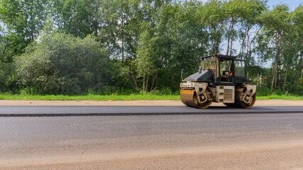 Asphalt roller machinery. Road repair works on the suburb highway