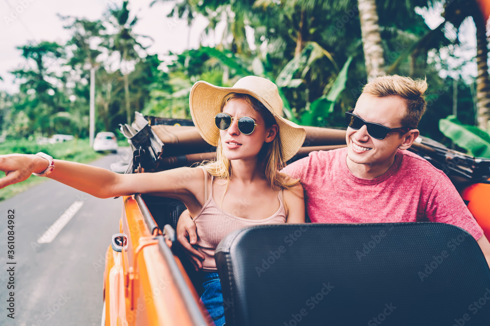 Wall mural romantic couple spending honeymoon journey on tropical island enjoying automobile excursion, young f