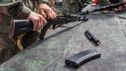 Military Soldier Is Training How To Disassemble Rifle AK-47