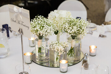 Flowers at a wedding reception, wedding venue, wedding bouquet, white roses, multi colour color flowers