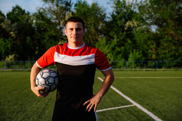 Soccer player with a ball in his hands