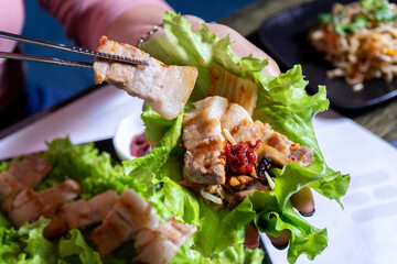 Hot asian meat dish with lettuce leaf
