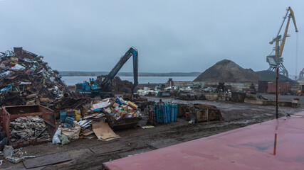 Reception and dispatch center for ferrous metal with loading cranes near the river