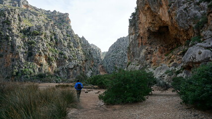 a hiker in the Torrent de Pareis, Serra de Tramuntana, Mallorca, Spain, in the month of January