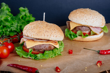 View of fresh tasty burger on wooden table. Food background.