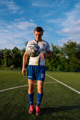 Young male soccer player juggles a ball on a soccer field © bo.kvk