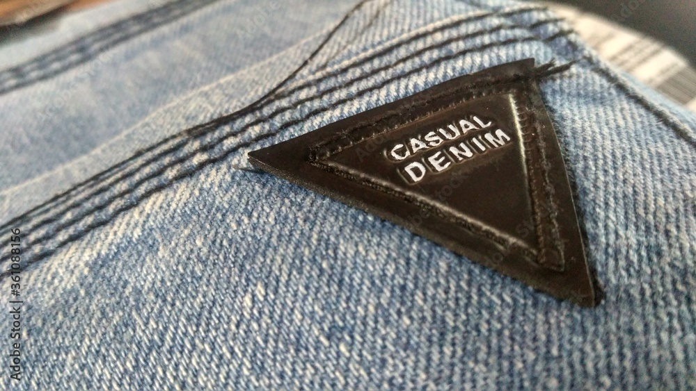 Wall mural Closeup shot of a label casual denim on jeans