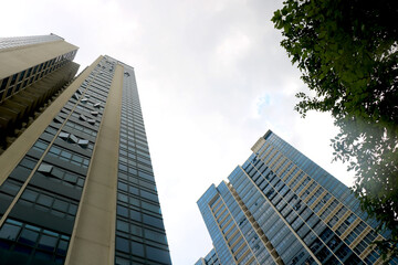 Obraz premium view to steel light blue background of glass high rise building skyscraper commercial modern city of future.