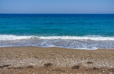 Beautiful stones beach in a sunny day with blue see and sky