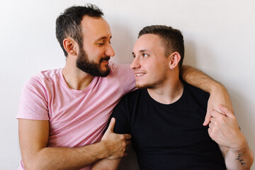 Obraz premium Gay couple laughing at home.