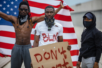 black lives matter protest in streets. Group of black people rebel opposing injustice while...