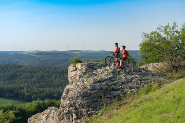 Grandmother and granddaughter riding their mountainbikes in the rocky landscape of Frankonian...