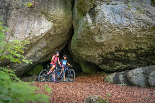 Grandmother and granddaughter riding their mountainbikes in the rocky landscape of Frankonian Switzerland in Bavaria, Germany