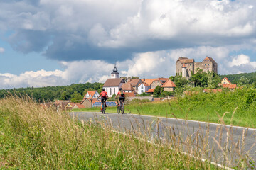 grandmother and granddaughter riding their mountain bikes in front of the awesome skyline of...