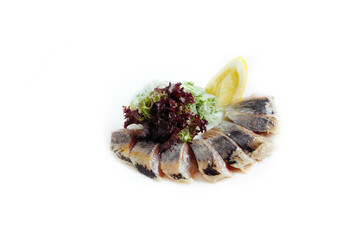 Pieces of salt fillet herring with lettuce isolated on the white