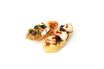 Bruschetta with pate, olives, meat and sauce isolated on the white
