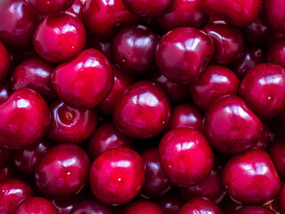 shiny large ripe red cherries closeup - food background