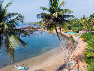 Beauty Pathem beach on the background of palm trees. Aerial view landscape. Goa state in India.