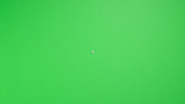 Stop Motion Animation_White paper ball unwrapping on green background_Green screen