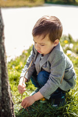 Little boy walks in a spring park