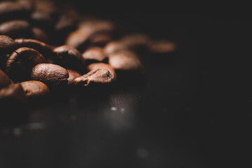 Roasted coffee beans placed on black table bar