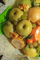 Fruit and floral green bouquet with apples and citrus