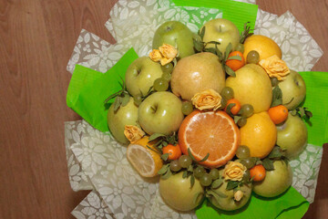 Fruit and floral green bouquet with apples and citrus
