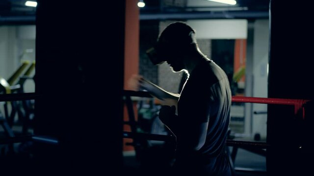 Male athlete is having a virtual boxing practice in the gym