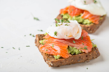 Sandwich with salmon, avocado and whole grain bread