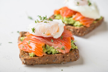 Sandwich with salmon, avocado and whole grain bread