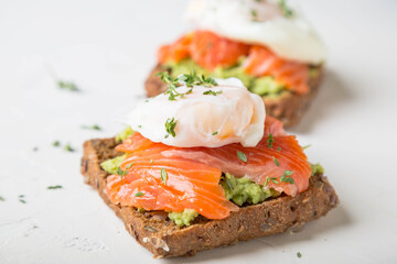 Sandwich with salmon, avocado and whole grain bread