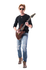Confident macho rock music young man playing electric guitar walks towards camera. Full length portrait isolated on white background. 