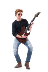 Young happy smiling handsome stylish rocker playing electric guitar looking away. Full length portrait isolated on white background. 