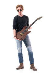 Stylish rock and roll guitarist holding and showing electric guitar looking at camera. Full length portrait isolated on white background. 