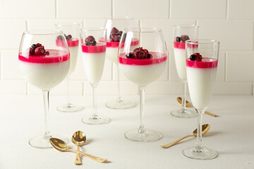 champagne glasses with panna cotta and strawberries