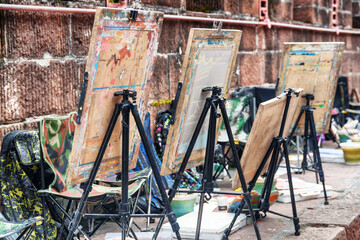 Easels by wall at old street of Phoenix Ancient Town