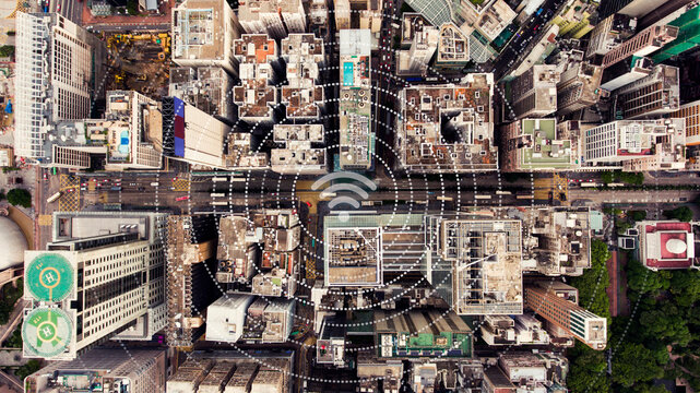 Top view aerial photo of a Hong Kong Global cityscape with development buildings, transportation, energy power infrastructure. Financial and business centers with infographics wireless connection icon