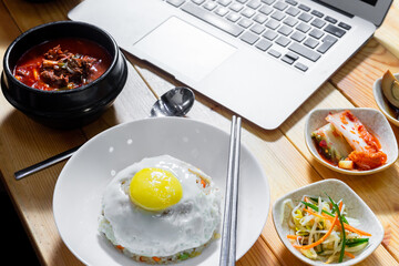 lunch time in korean restourant with laptop 
