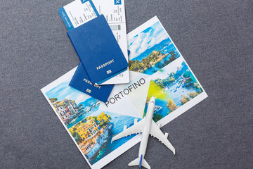 Fototapeta na wymiar Flight tickets with passports, model of airplane and map on gray background.