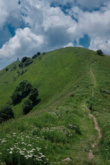 Obraz premium girl hiking on alpine trail in the palanzone peak - Como Lombardy.