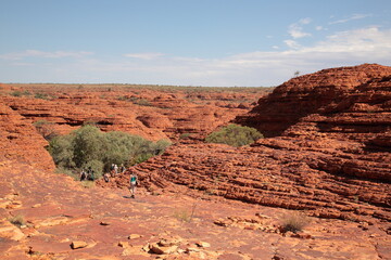 Fototapeta premium Tourists hiking in Kings Canyon outback central Australia