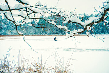 Fototapeta na wymiar winter fishing on a frozen forest lake