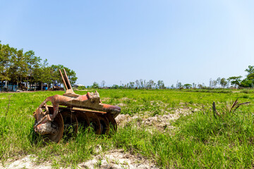 closeup part of the old tractor car in the rice field. over light in the background