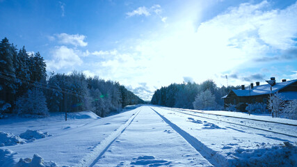 Fototapeta na wymiar Railway in snow. Winter landscape with empty rail tracks